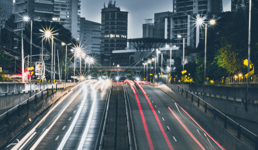Highway at night with the light trails from cars 