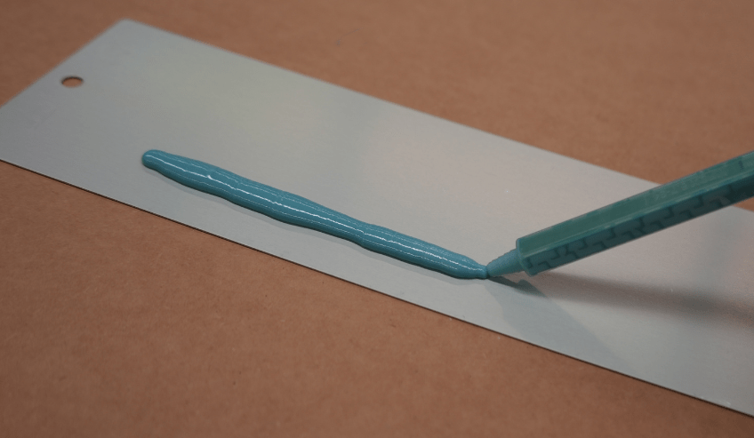 Applying silicone adhesive on a metal surface