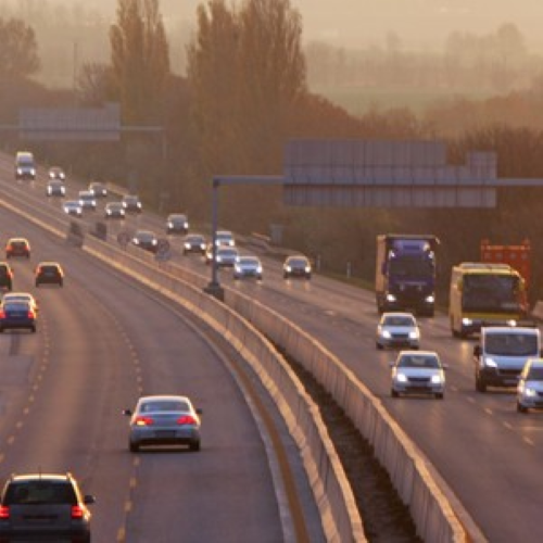 Vehicles on highway at evening