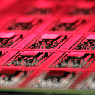 Close up image of printed circuit board under red light